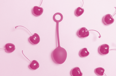 kegel ball surrounded by cherries on flat surface