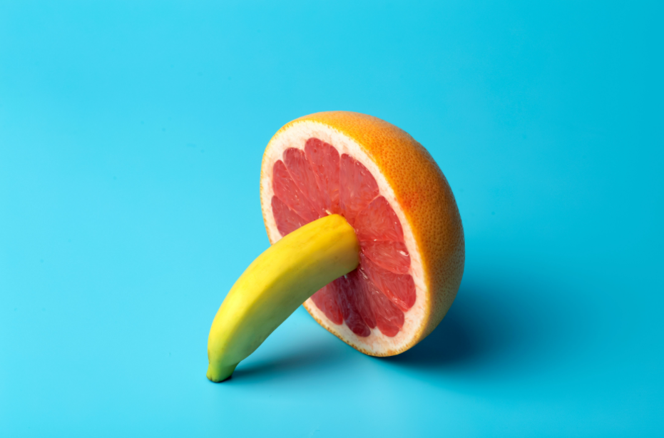 photo of a banana inside of a grapefruit to show a visual of soaking sex, or a penis inside of a vagina