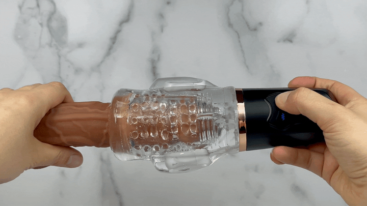 GIF showcasing suction power of masturbator on a dildo