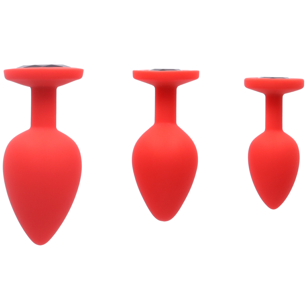 Large, medium, and small red silicone butt plug with black jewel 