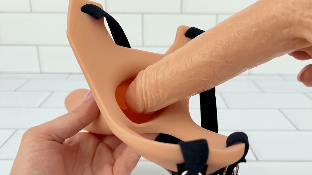 GIF of dildo being inserted inside hollow opening of Silicone Hollow Strap-On To Enhance Your Erections