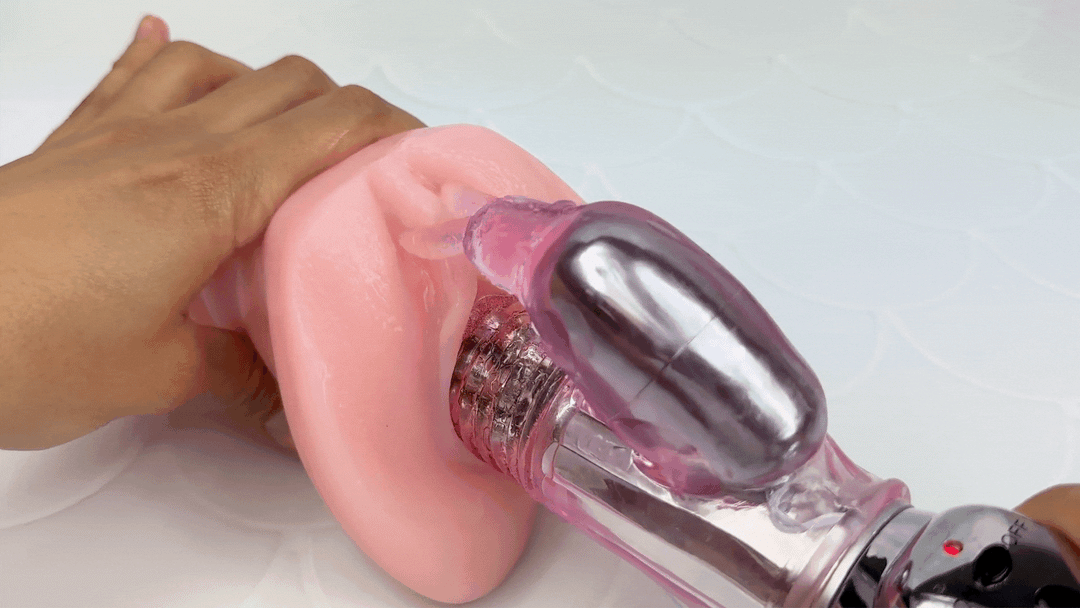GIF of toy rotating inside of a model of a vagina while the rabbit ears tease the clitoris with vibrations