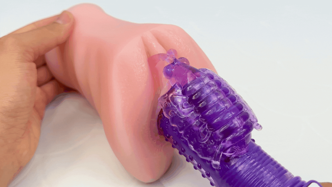 GIF of dual-action vibe inserted into a model of a vagina with a close-up of the rabbit ears teasings the clitoris