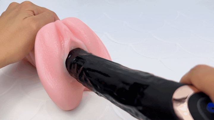 GIF of dildo thrusting in and out of a model of a vagina