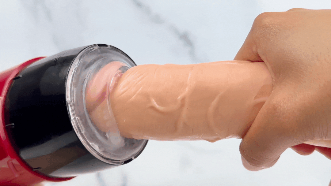GIF of sucking masturbator being used on the tip of a dildo