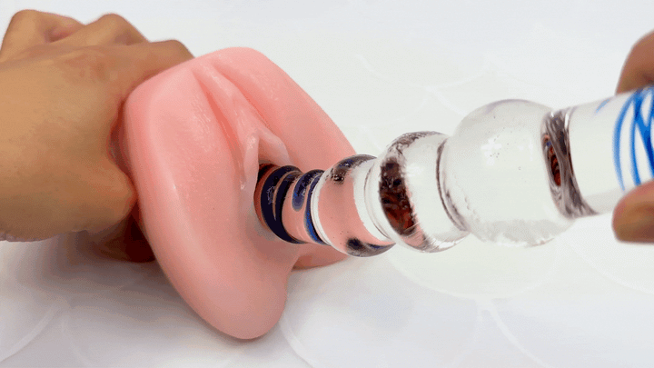 GIF of glass dildo thrusting in and out of a vagina