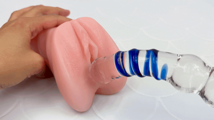 GIF of glass dildo being rubbed on a model of a vagina