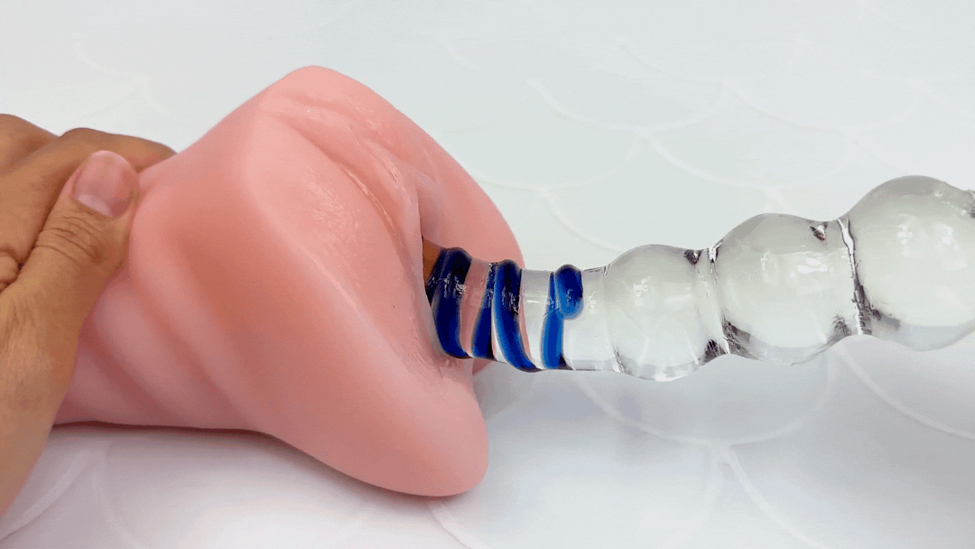 GIF of glass dildo thrusting in and out of a vagina - side view