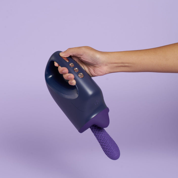 Top view of purple sex machine being held in hands