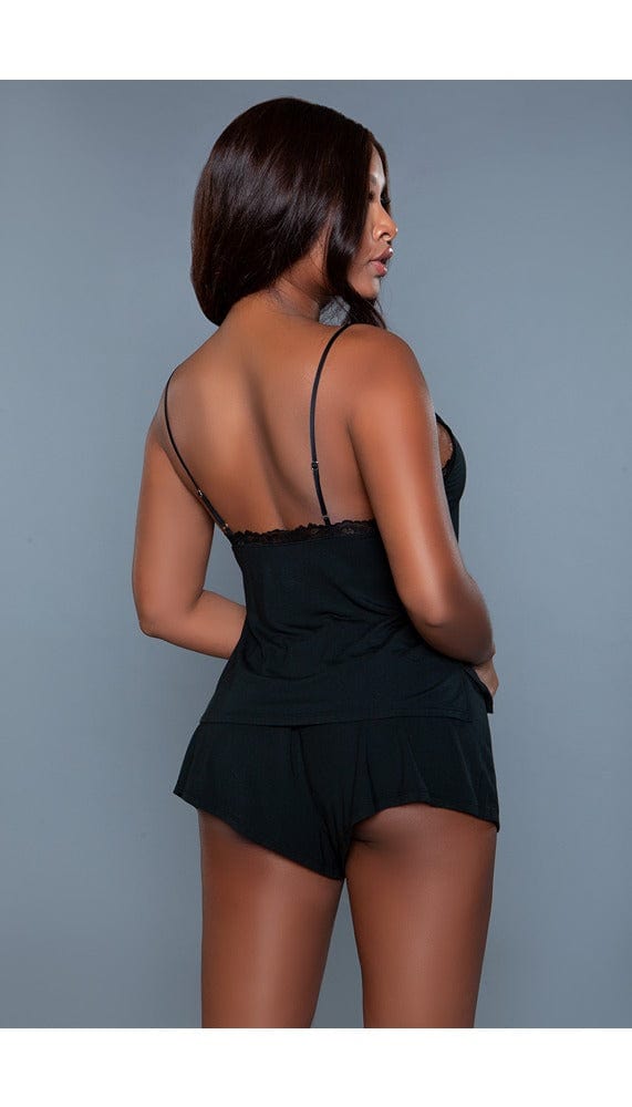 Model wearing 2 pc v-neckline cami set with lace trim adjustable straps and elastic waist shorts in black facing back right
