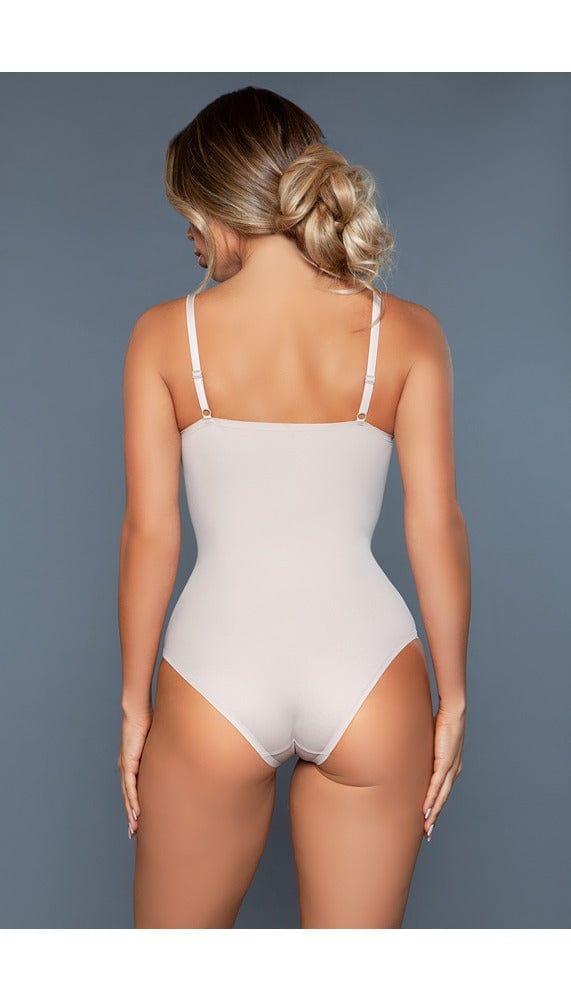 Model wearing seamless deep v bodysuit with adjustable straps and silky mesh design in beige facing back