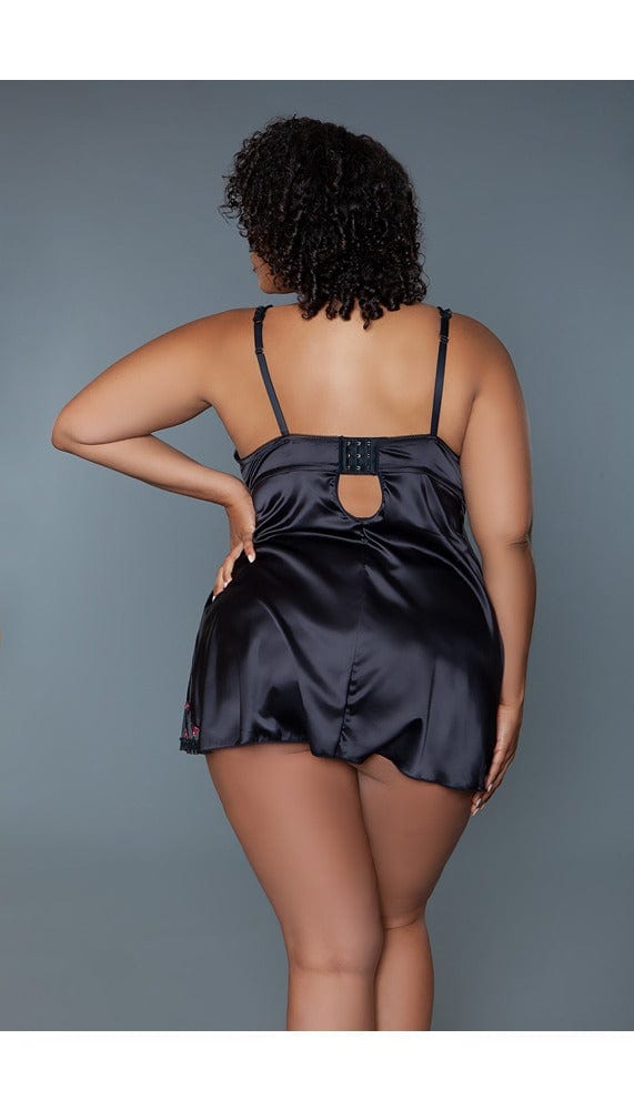 Back view of black babydoll dress with triple hook and eye closure.