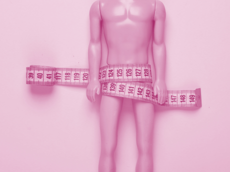 ken doll with measuring tape wrapped around groin