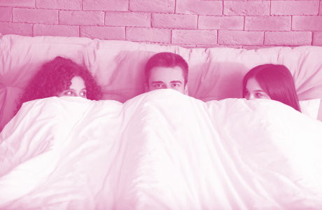 man in bed with 2 women 