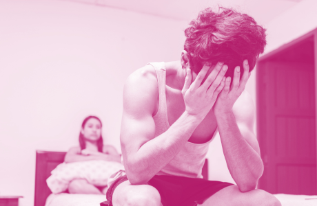 Worried man in bed with erectile dysfunction. Concept of crisis and couple problems in bed, Worried man sitting on the side of the bed and angry wife