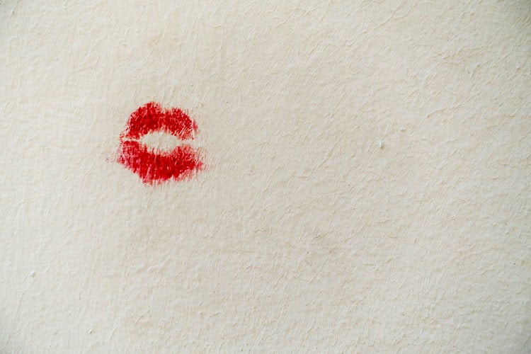 red lipstick on a white wall