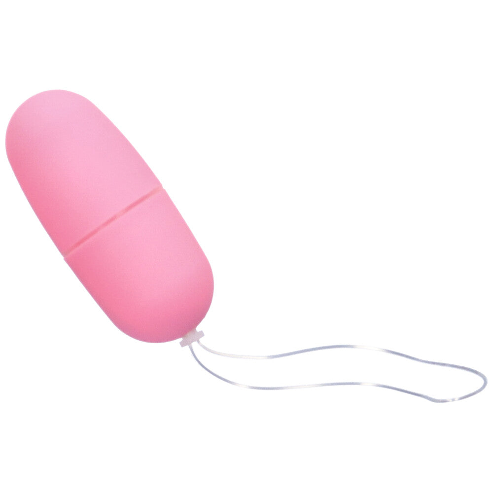 Bird's eye view of smooth pink vibrating egg with retrieval cord.