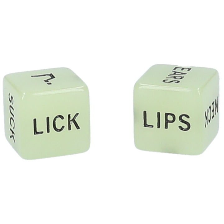 A pair of glow-in-the-dark foreplay dice with instructions on each face of one die and body parts on each face of the other die.