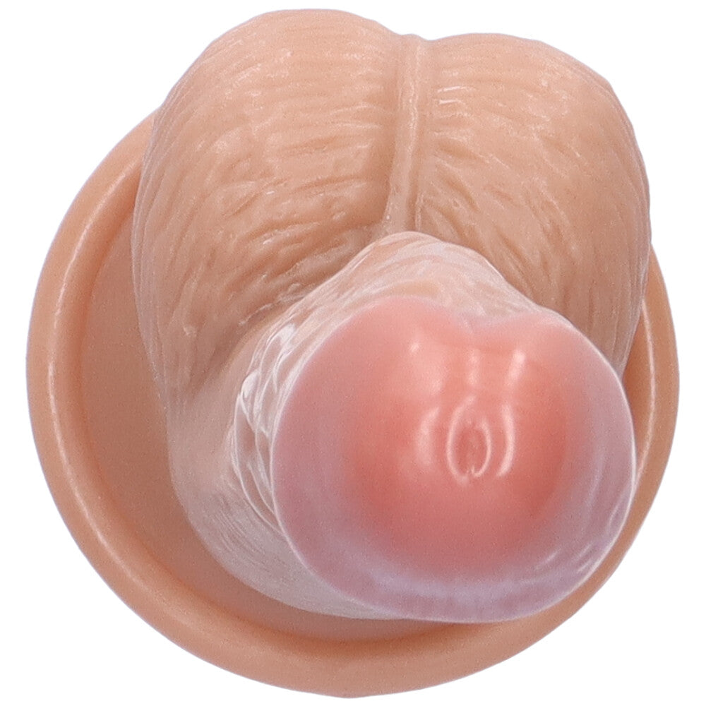 Top view of beige suction cup dildo with a close-up of penis tip.