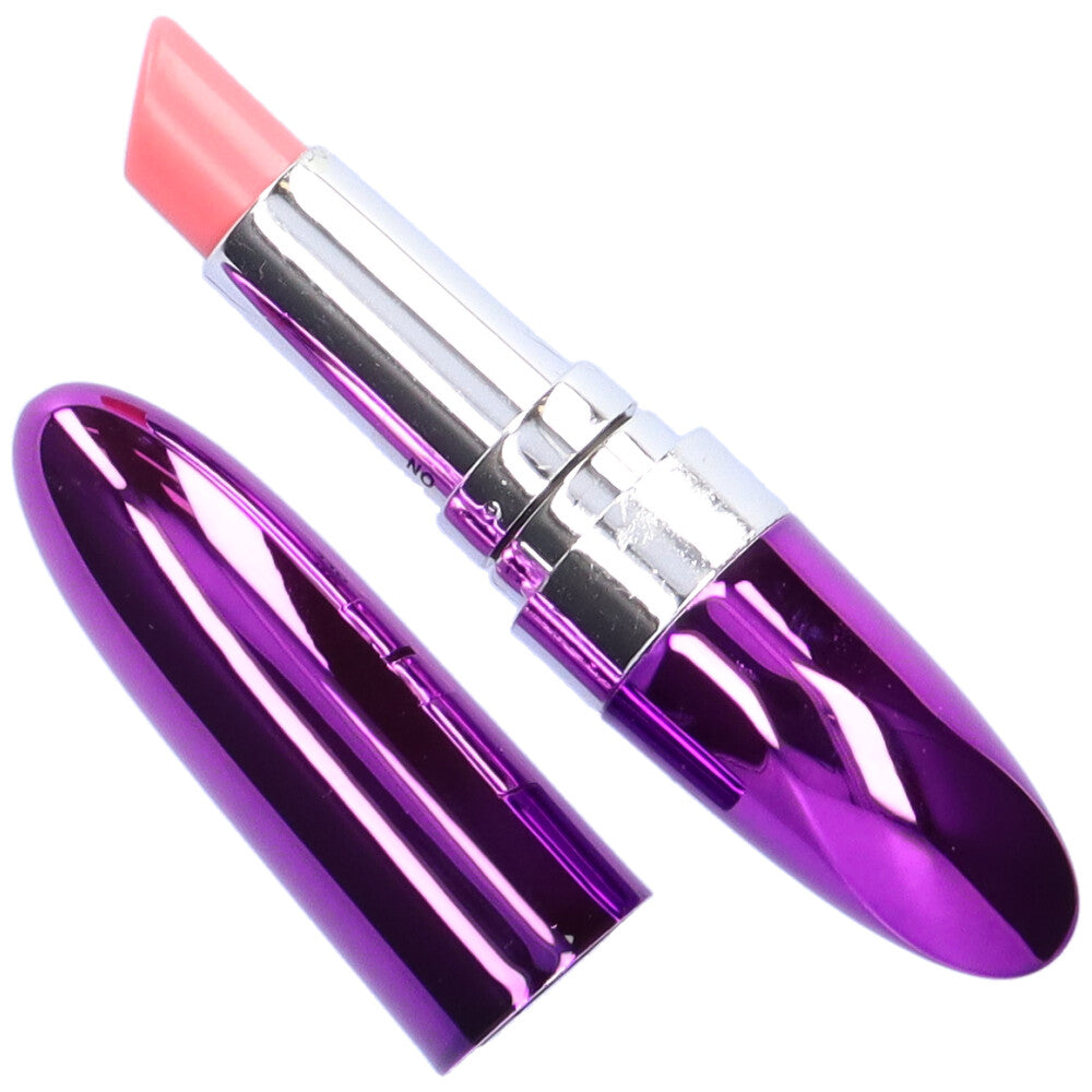 Bird's eye view of purple discreet lipstick vibe with cover taken off and at its side.