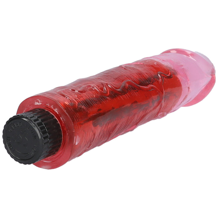 Pink 8" vibrating dildo lying on its side with detailed view of raised veins on the shaft.