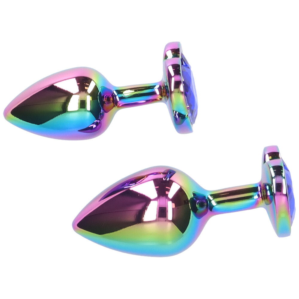 Small and medium blue jeweled metal rainbow butt plugs lying next to eachother.