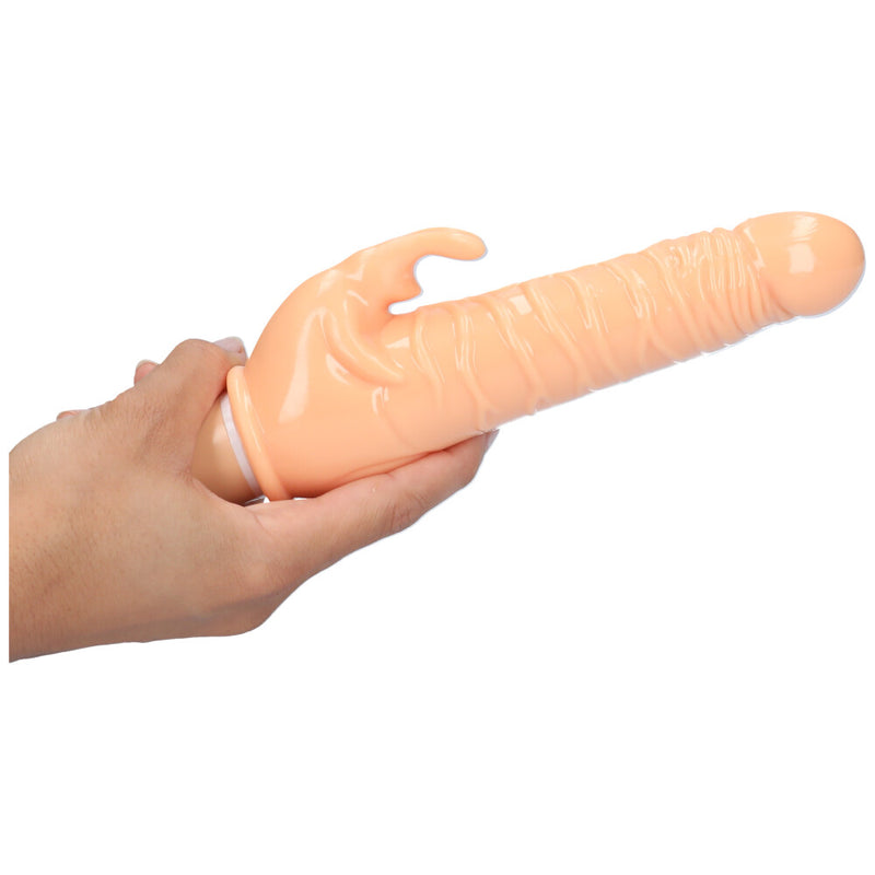 A hand holding the Beige Lifelike Power Rabbit Vibrator showing its side.