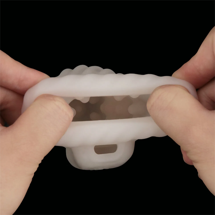 hands pulling Knights Ring Vibrating Dual Purpose Sleeve-Spiral sides to show inner pleasure nubs 