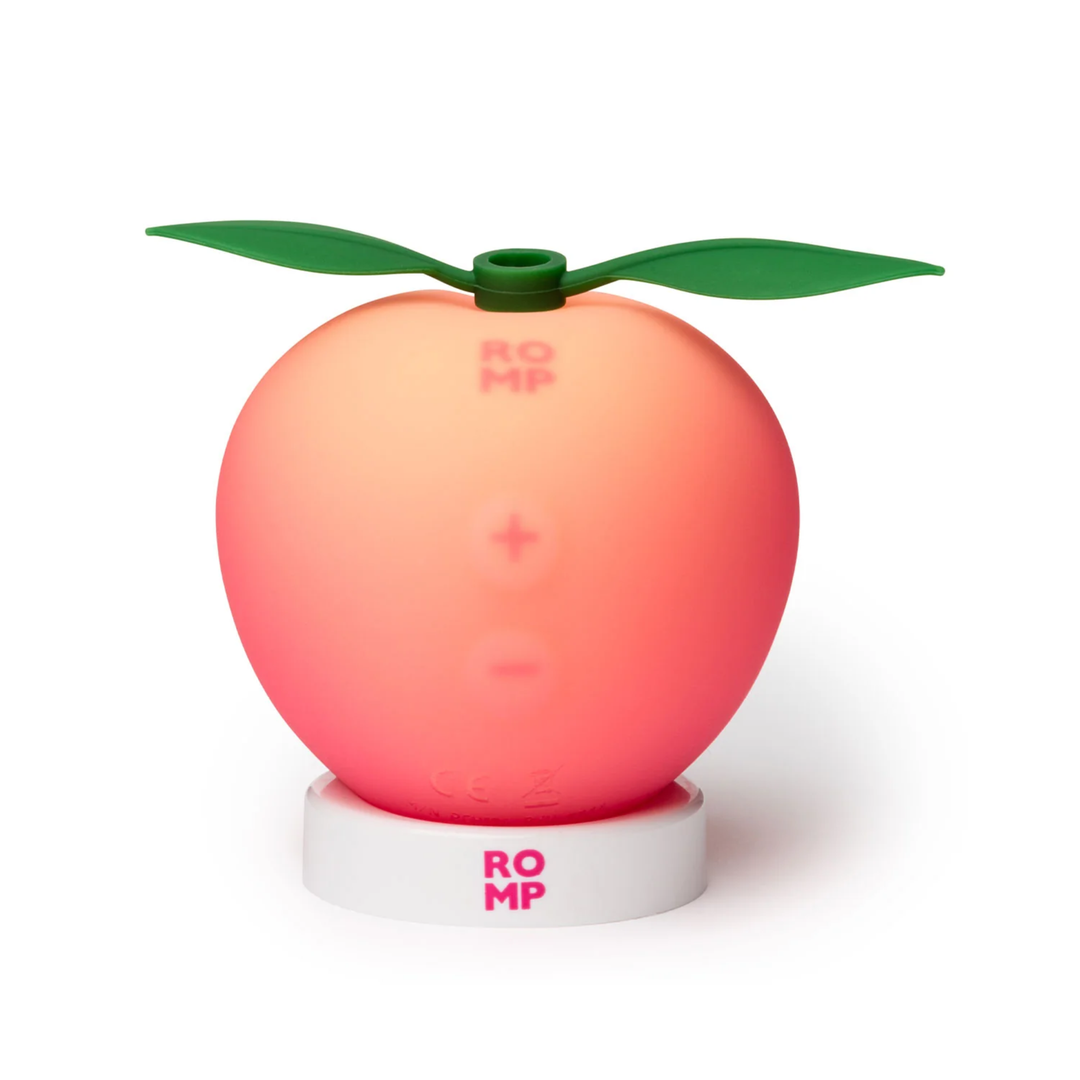 ROMP Pink Peach Rechargeable Clitoral Stimulator as seen on a stand 