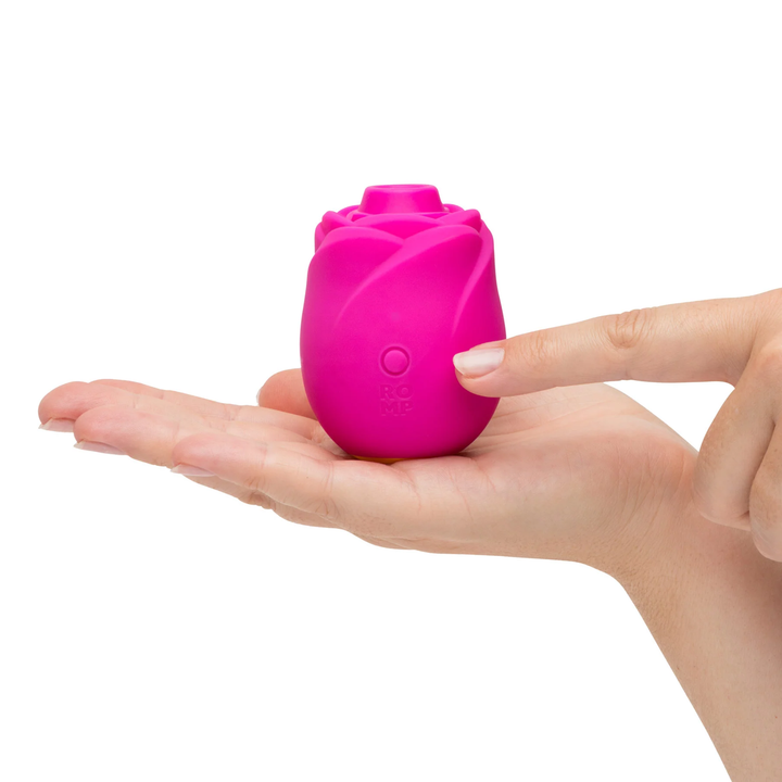 fingers pressing power button on Romp Rose 2.0 Rechargeable Silicone Air Clitoral Stimulator
