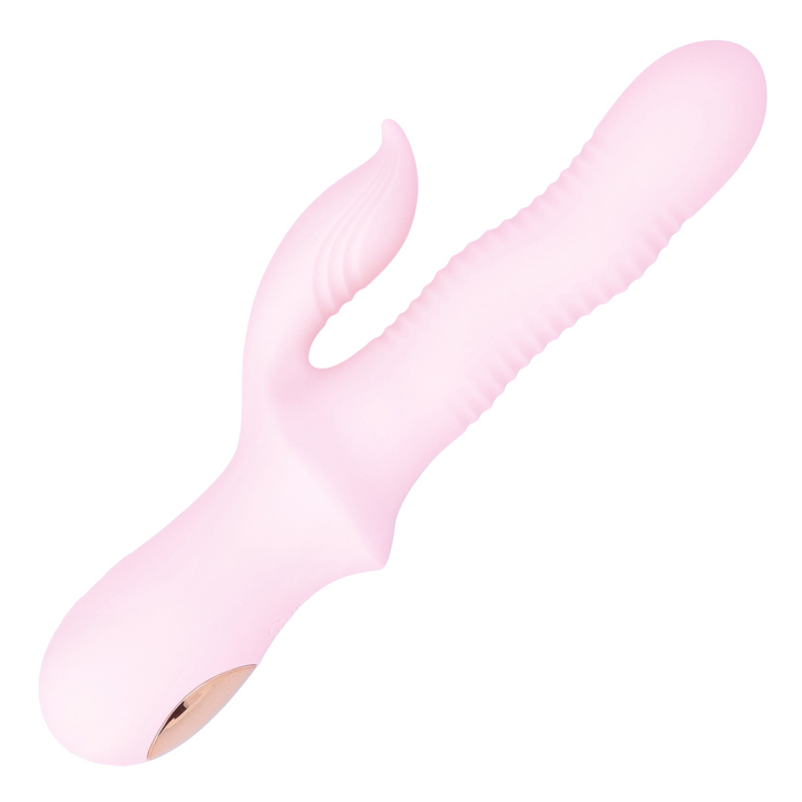 Pink wave action rabbit dildo as seen from birds eye view laying on its side 