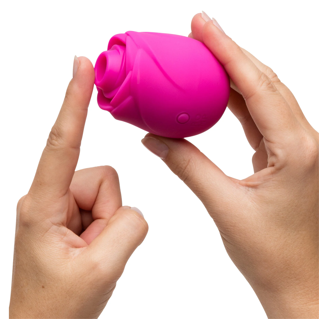 fingers pressing against air hole from Romp Rose 2.0 Rechargeable Silicone Air Clitoral Stimulator