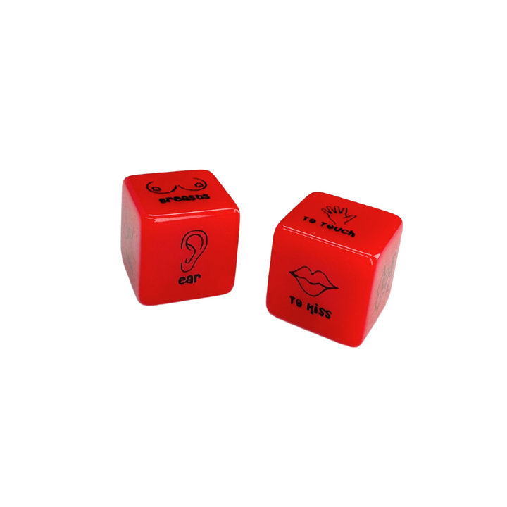 A pair of red foreplay dice with body parts on one die and directions on the other. This image shows ear & breasts on one die and "to touch" and "to kiss" on the other die.