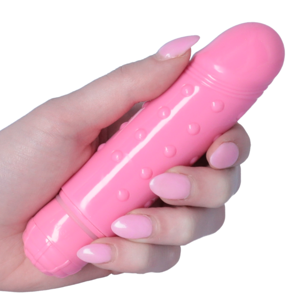 hand holding Mini Dotted Vibrator pink