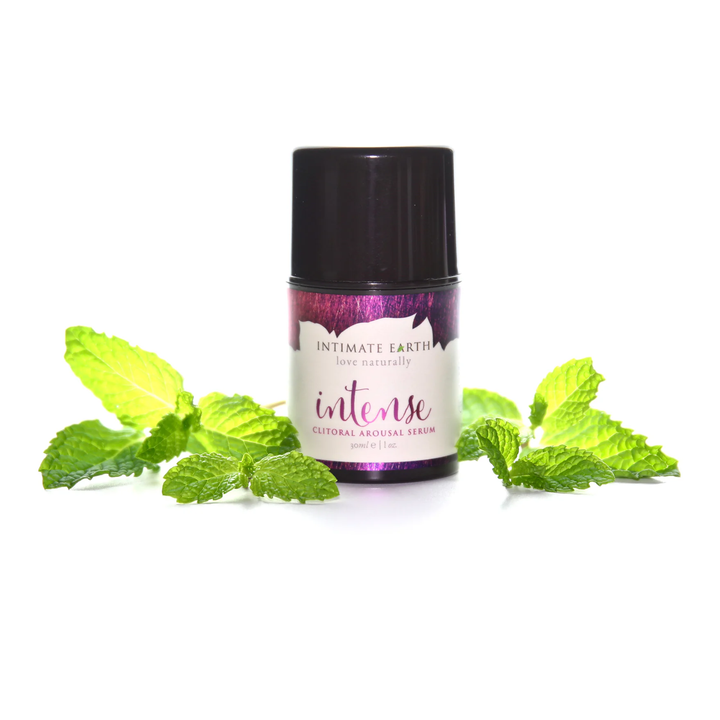 Intimate Earth Intense Clitoral Arousal Serum surrounded by mint leaves 