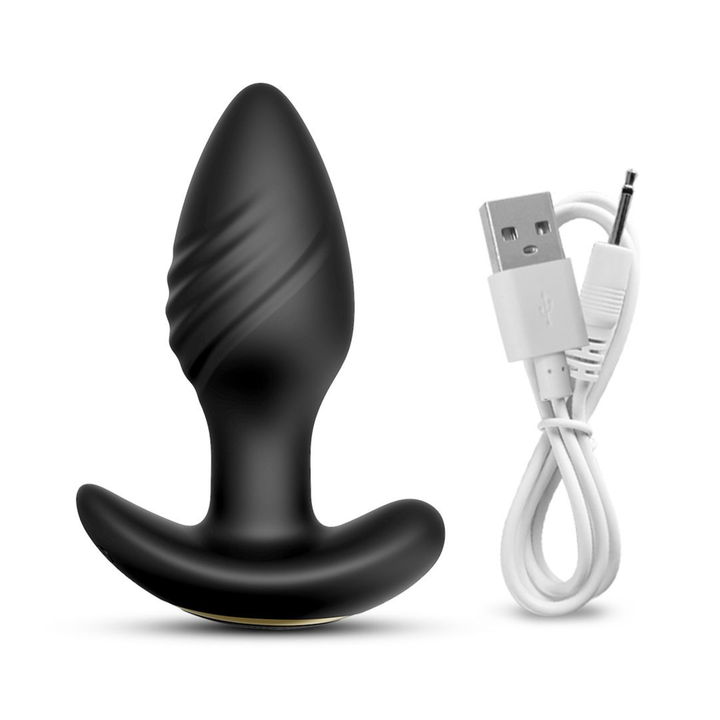 Vibrating and Rotating Butt Plug as seen next to charging cable