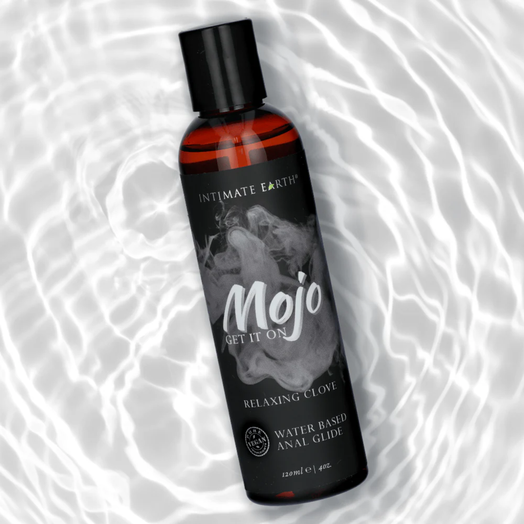 MOJO Water Based Anal Relaxing Glide Lubricant 4oz with water in the background 