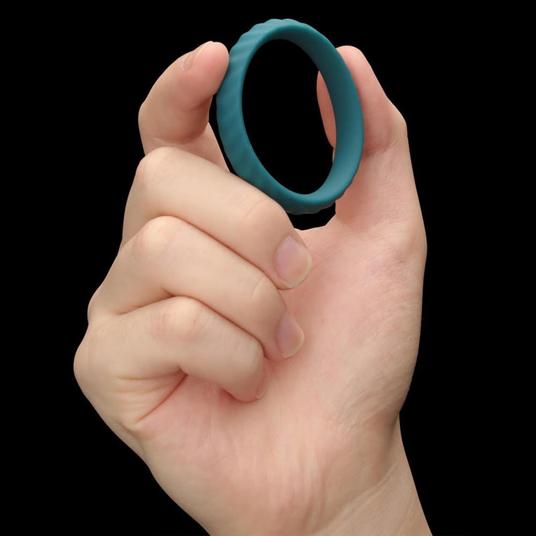 hand holding custom fit ring from Pinnacle Pro Grip Lock Set Cock Ring 