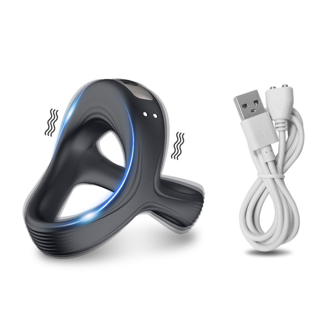Vibrating Dual Cock Ring next to a charging cable 