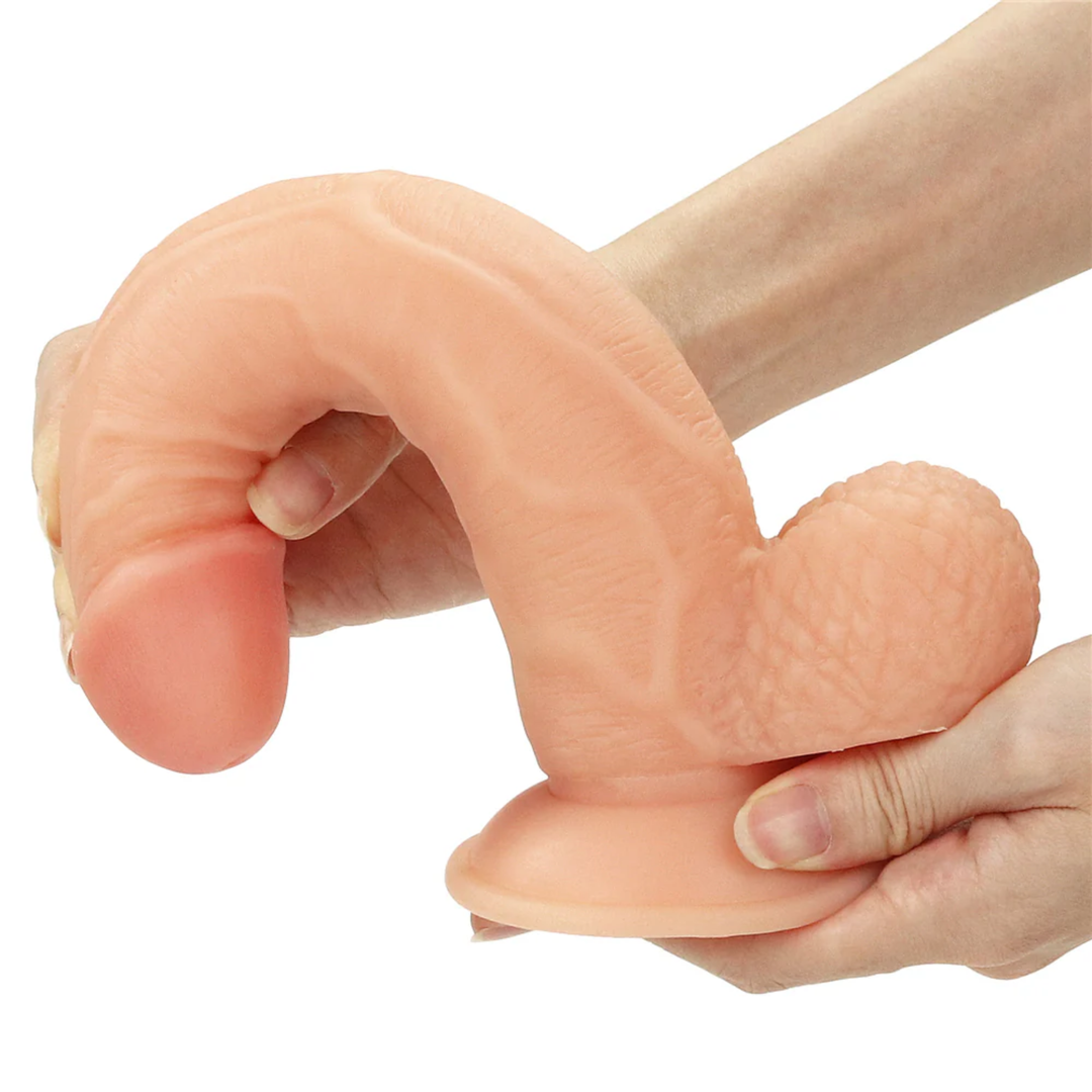 beige 8.5 inch dildo being bent to show flexibility 