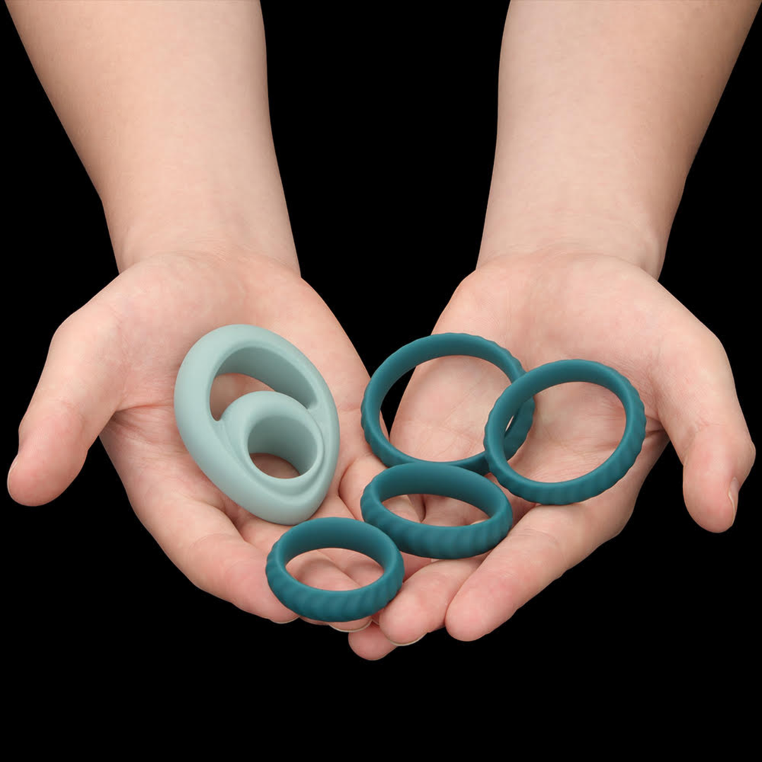 hands holding all contents from Pinnacle Pro Grip Lock Set Cock Ring