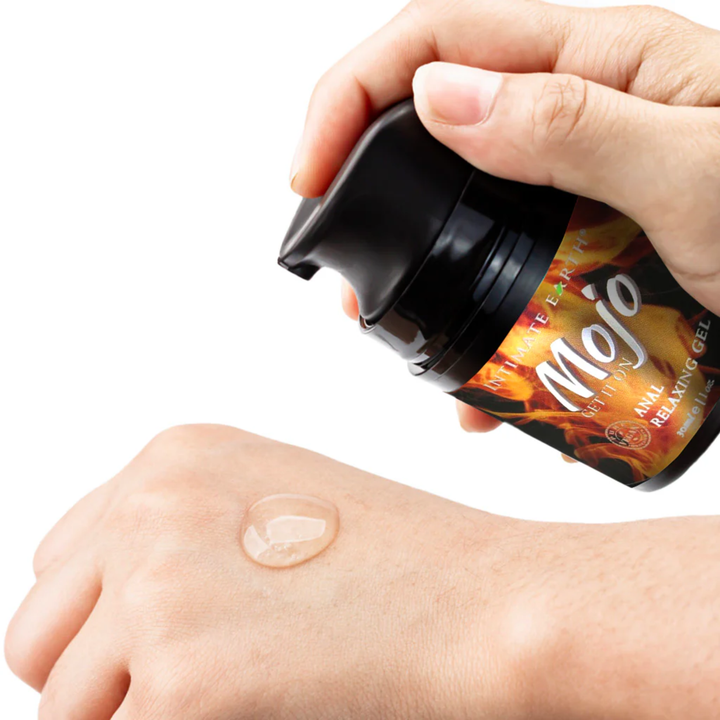 hand pumping MOJO Clove Oil Anal Relaxing Gel Lubricant 1oz onto back of hand 