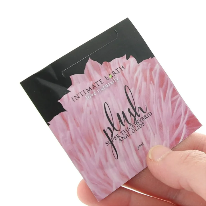 hand holding 3 ml packet from Intimate Earth Plush Hybrid Anal Glide Lubricant