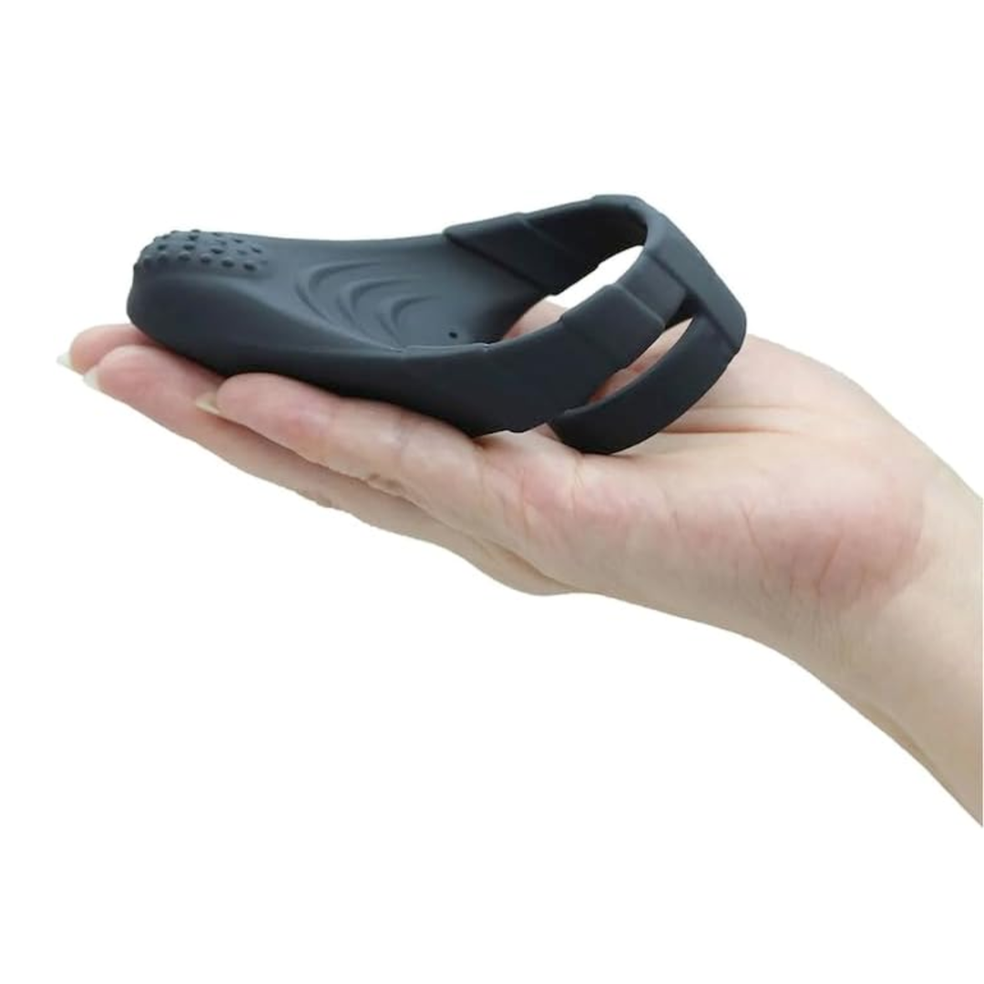 hand holding Sperm Locking Dual Cock Ring with Taint Teaser
