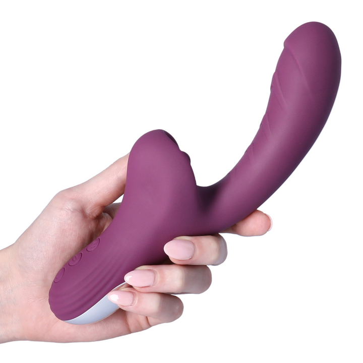 hand holding purple Licking Dual action Vibrator 