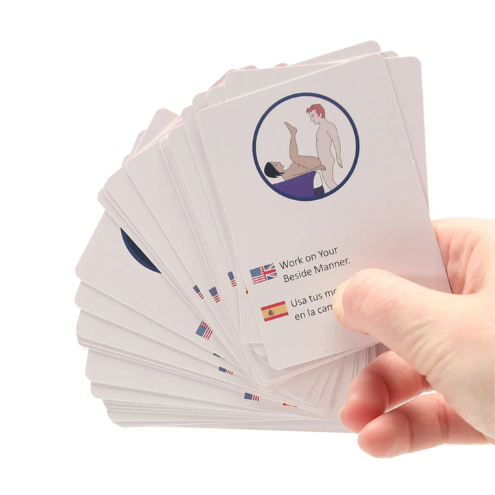 hand holding several cards from Tits for Tat Couples Game