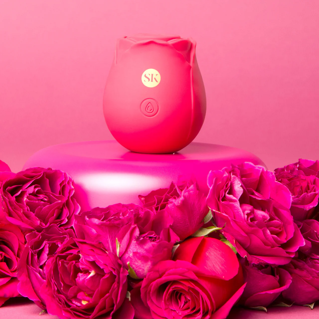 Secret Kisses Rosegasm Air Rechargeable Silicone Clitoral Stimulator surrounded by roses 