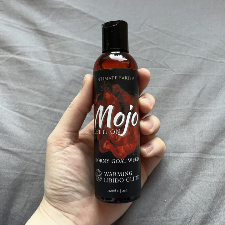 hand holding MOJO Horny Goat Weed Libido Warming Glide Lubricant 4oz bottle 