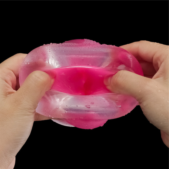 hands spreading Lumino Play Male Masturbator opening to show pink inside 