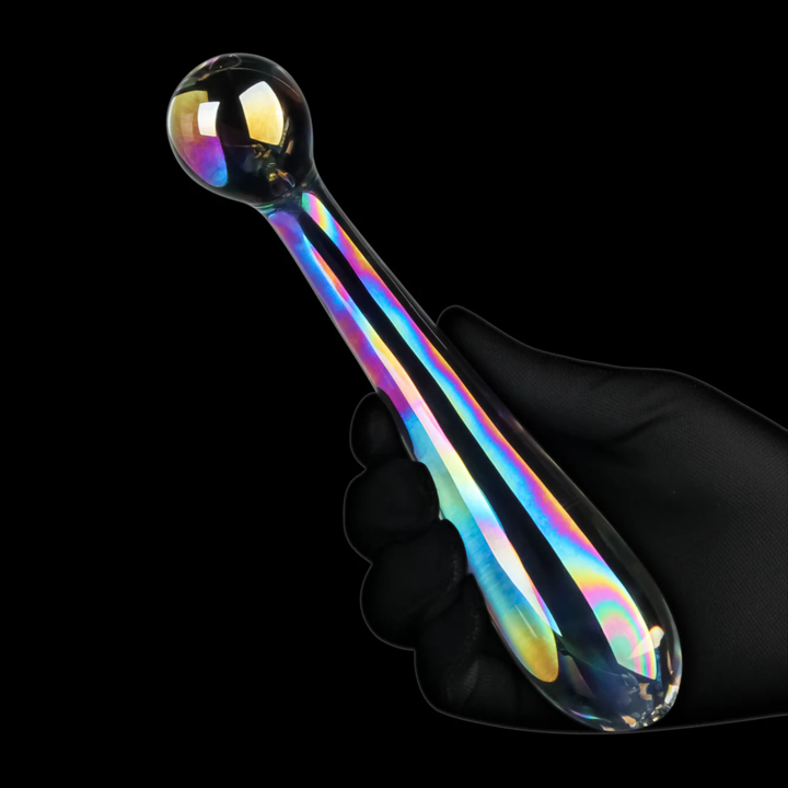 gloved hand holding Lovetoy Twilight Gleam Alluring Arc Double Ended Glass Dildo 